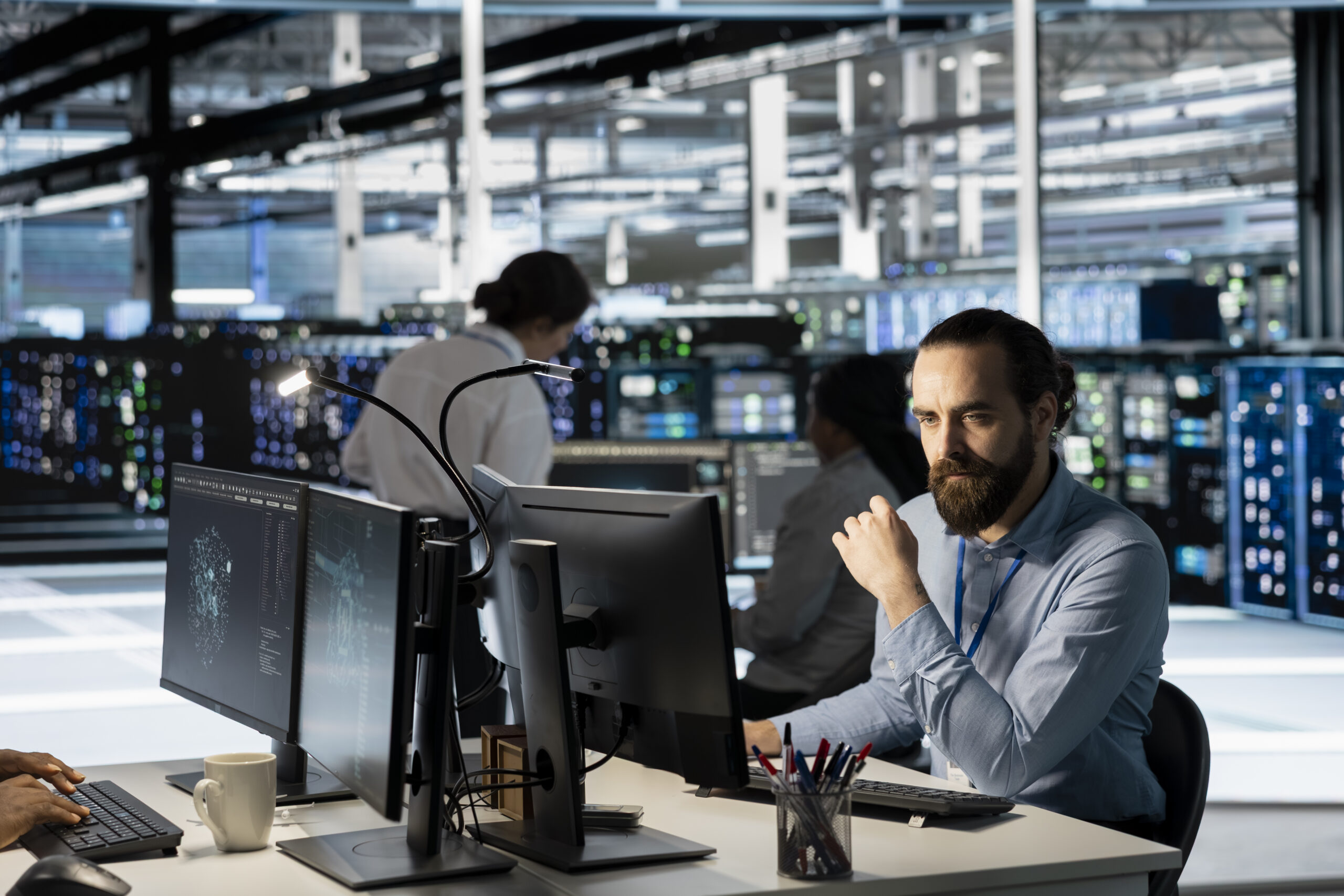 Technician using PC in data center to update server tech, configuring equipment using software tools. Server room employee reviewing hardware analytics, ensuring reliable network operations